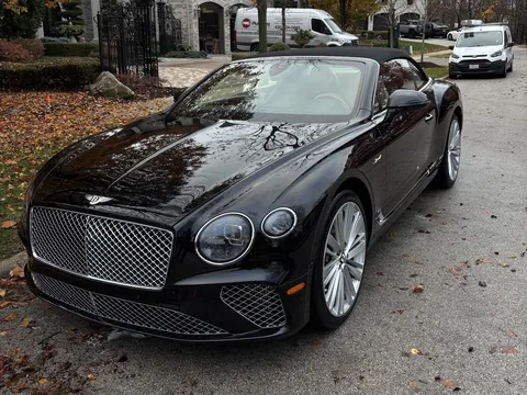 Black Bentley Continental GT convertible parked in a driveway after a detail