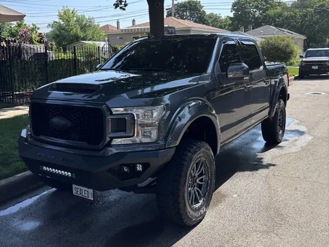 Lifted Ford F-150 pickup truck parked on a residential street after a detail