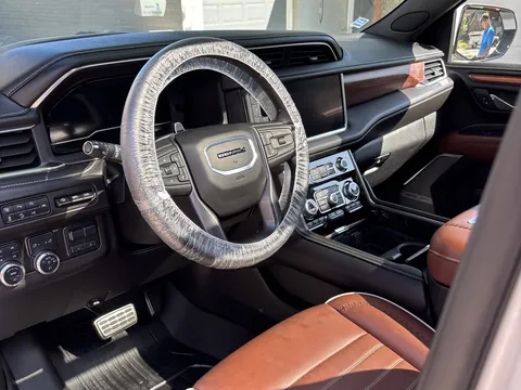 GMC interior with tan and black leather seats and steering wheel after a detail