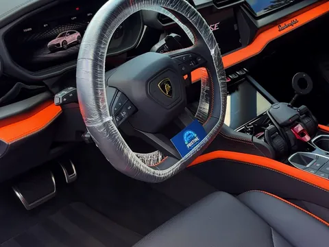 Lamborghini Urus interior with the steering wheel protected and a Pristine Detailing card on it
