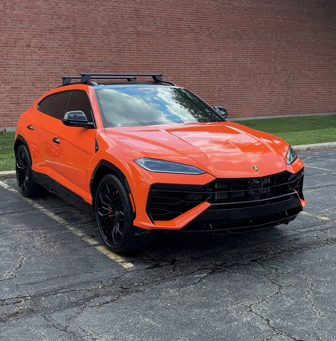 Orange Lamborghini Urus in a parking lot after a full detail