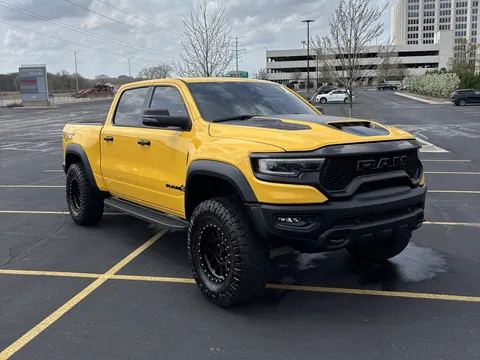 Yellow Ram TRX pickup truck parked in a lot after a detail